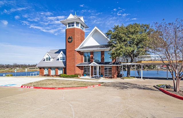 view of front of home with a water view