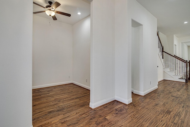 spare room with ceiling fan and dark wood-type flooring