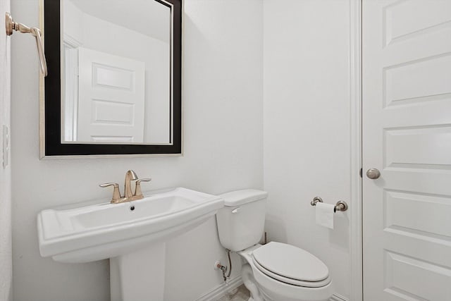 bathroom featuring toilet and sink