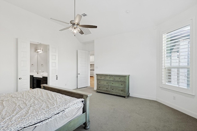 carpeted bedroom featuring ensuite bathroom, lofted ceiling, and ceiling fan