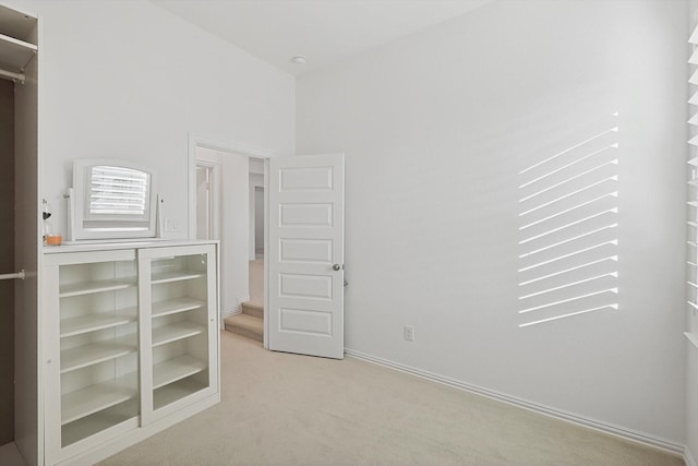 unfurnished bedroom with light colored carpet