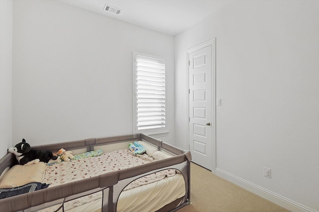 bedroom featuring light colored carpet