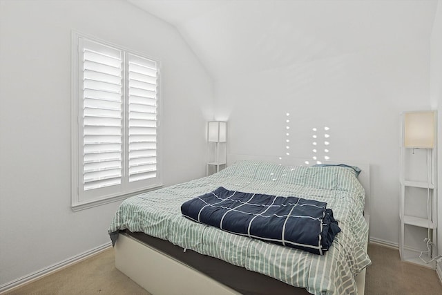 carpeted bedroom featuring vaulted ceiling