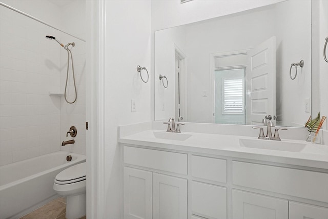 full bathroom featuring tile patterned floors, vanity, toilet, and tiled shower / bath combo