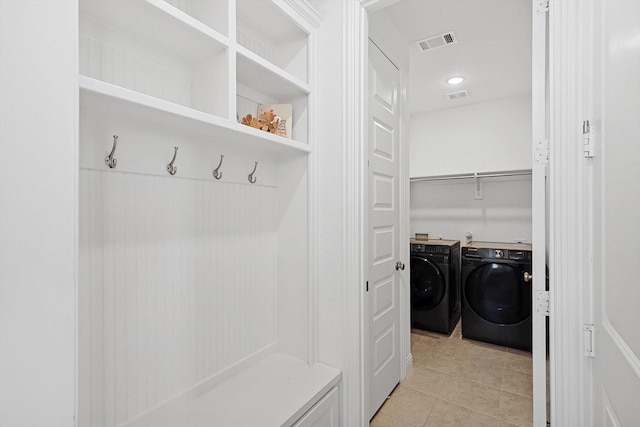 mudroom featuring light tile patterned floors and washer and clothes dryer