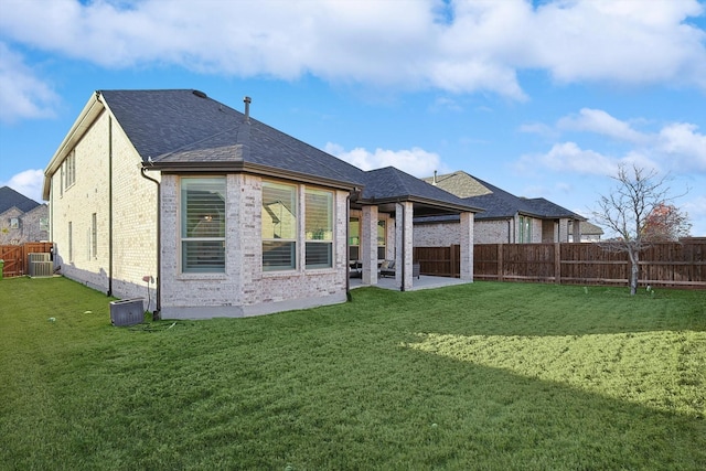 back of property featuring cooling unit, a patio area, and a lawn