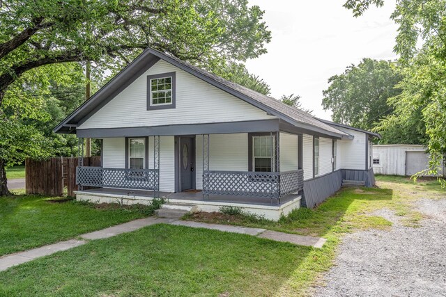 bungalow featuring a porch and a front yard