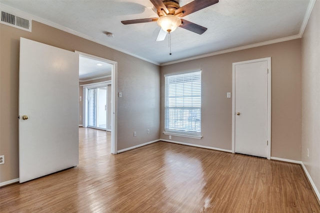 spare room with crown molding, ceiling fan, and light hardwood / wood-style flooring