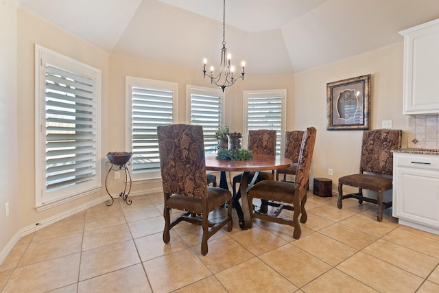 dining room featuring light tile patterned floors, lofted ceiling, and a notable chandelier