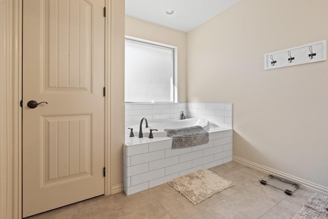 bathroom featuring tile patterned flooring and a relaxing tiled tub