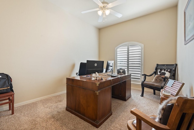 office area with a ceiling fan, light carpet, and baseboards