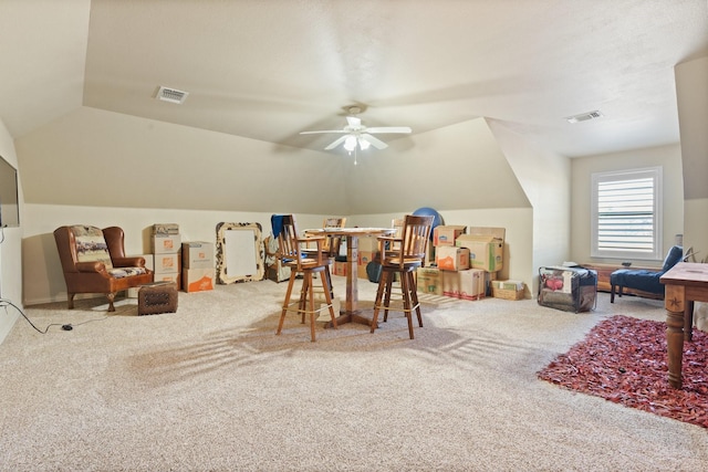 recreation room with lofted ceiling, visible vents, ceiling fan, and carpet