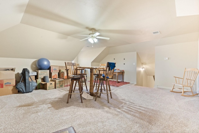 recreation room featuring carpet, ceiling fan, and vaulted ceiling