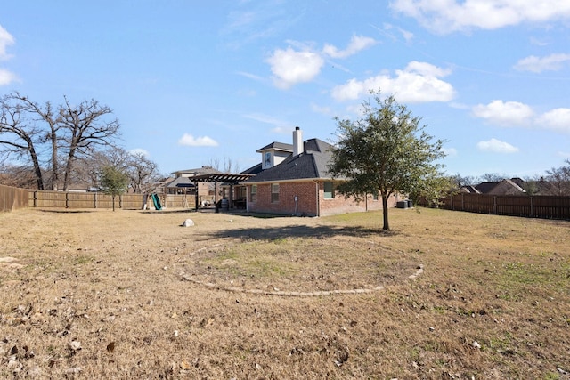 view of yard with a fenced backyard, a playground, and a pergola