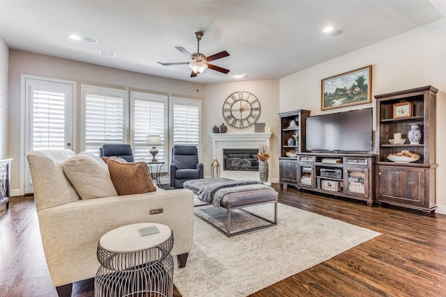 living room with dark hardwood / wood-style floors and ceiling fan