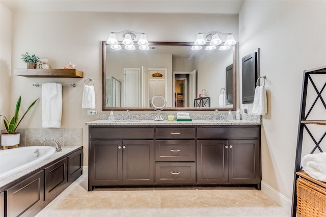 bathroom featuring tile patterned flooring, shower with separate bathtub, and vanity