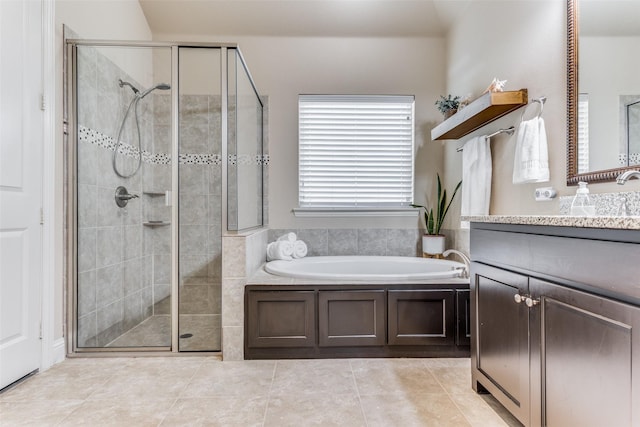 bathroom with vanity, tile patterned floors, and plus walk in shower