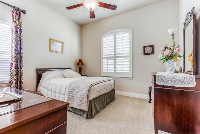 bedroom featuring light carpet and ceiling fan