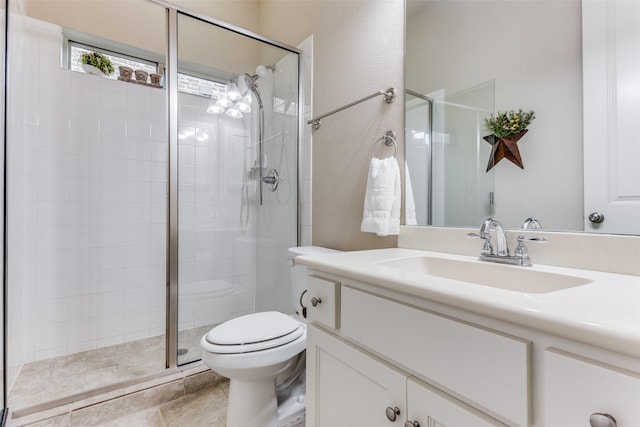 bathroom featuring an enclosed shower, vanity, and toilet