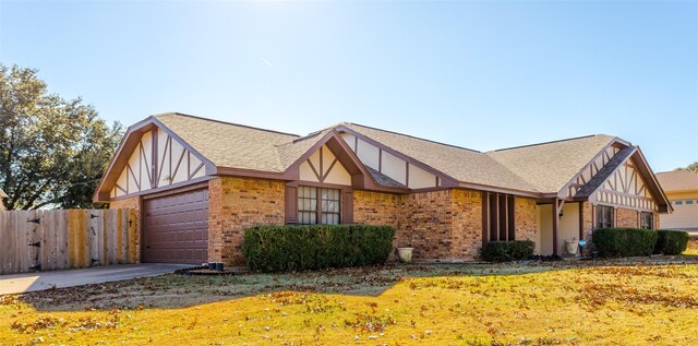 view of front of home featuring a front yard and a garage