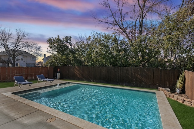 view of pool at dusk