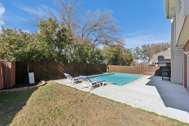 view of pool featuring a lawn and a patio