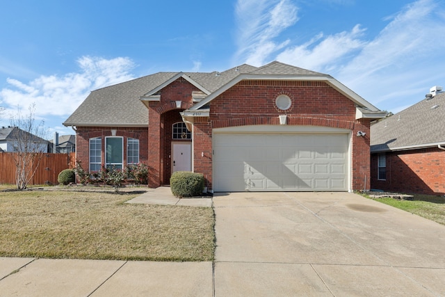 view of property with a garage and a front lawn