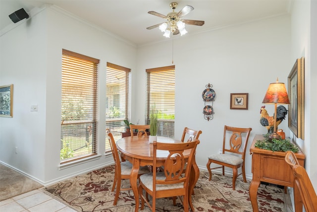 dining room featuring ceiling fan, ornamental molding, and light tile patterned floors