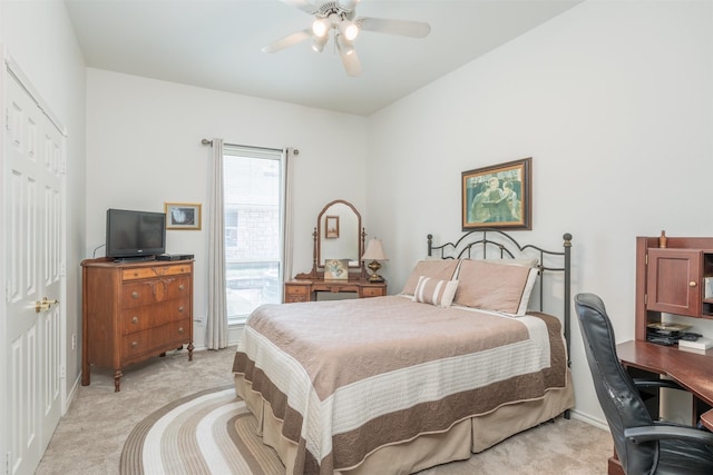 carpeted bedroom with ceiling fan and a closet