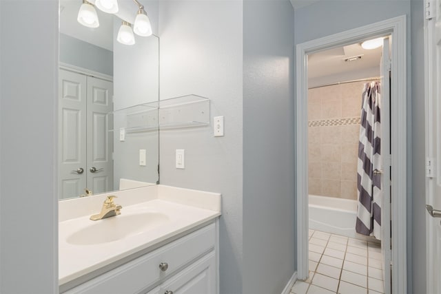 bathroom with tile patterned floors, shower / bath combo with shower curtain, and vanity