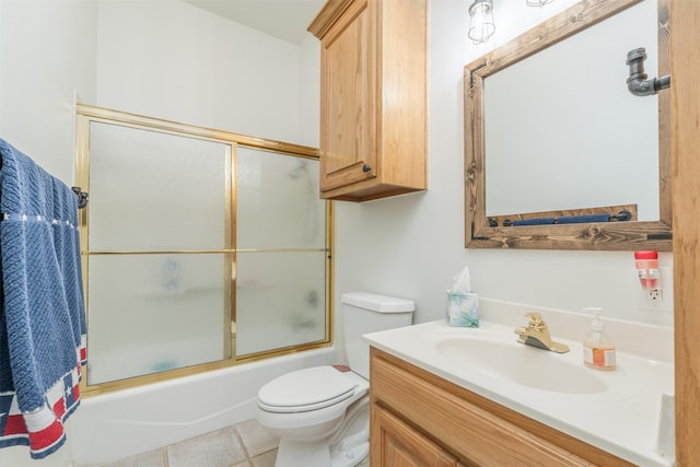 full bathroom with tile patterned floors, toilet, vanity, and combined bath / shower with glass door