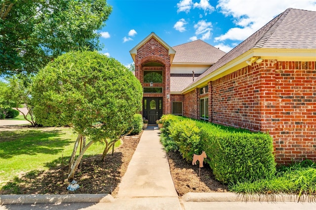 property entrance with a yard