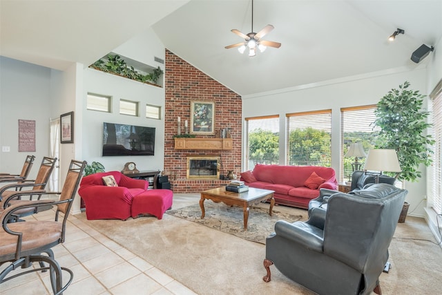 living room featuring light tile patterned floors, high vaulted ceiling, a brick fireplace, and ceiling fan