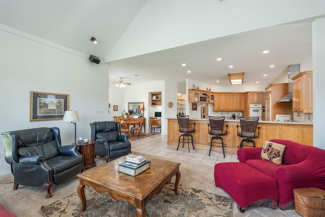 living room featuring light tile patterned floors, high vaulted ceiling, and ceiling fan