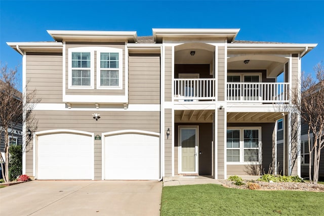 view of front of home featuring a balcony, a garage, and a front lawn