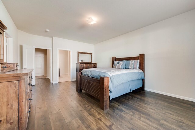 bedroom with dark wood-type flooring