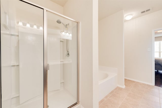 bathroom featuring plus walk in shower and tile patterned floors