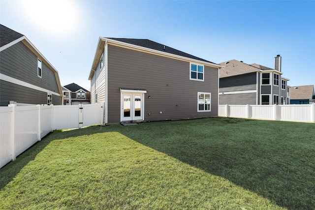 back of house featuring a lawn