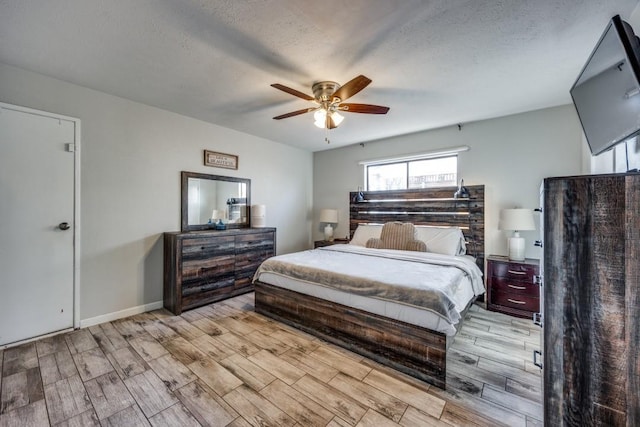 bedroom featuring a textured ceiling and ceiling fan