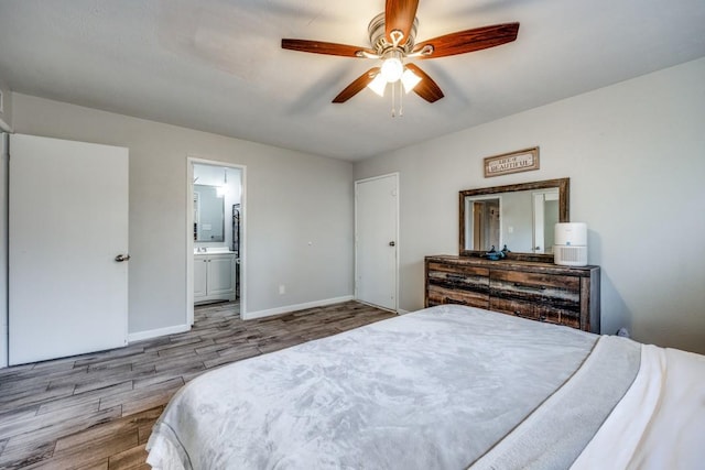 bedroom featuring hardwood / wood-style flooring, ceiling fan, and connected bathroom