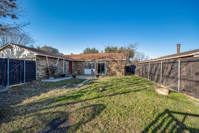 back of property featuring a lawn