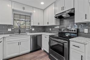 kitchen featuring sink, white cabinets, dark hardwood / wood-style floors, and appliances with stainless steel finishes