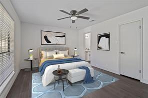 bedroom with ceiling fan and dark hardwood / wood-style floors