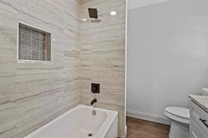 full bathroom with vanity, bathtub / shower combination, and toilet