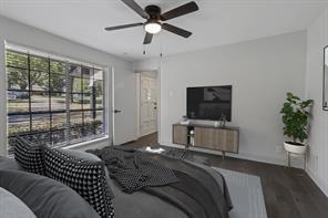 bedroom with dark hardwood / wood-style floors and ceiling fan