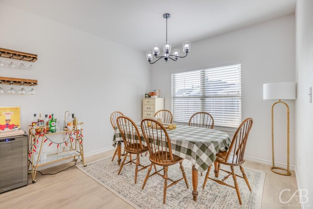 dining room featuring light hardwood / wood-style flooring and a notable chandelier