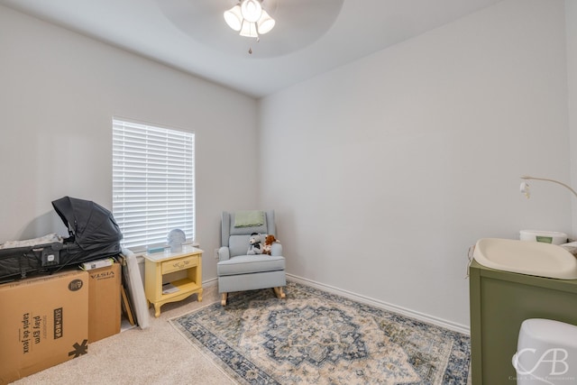 interior space with carpet floors and ceiling fan