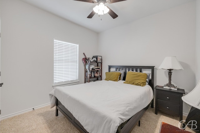 bedroom with ceiling fan, light carpet, and multiple windows