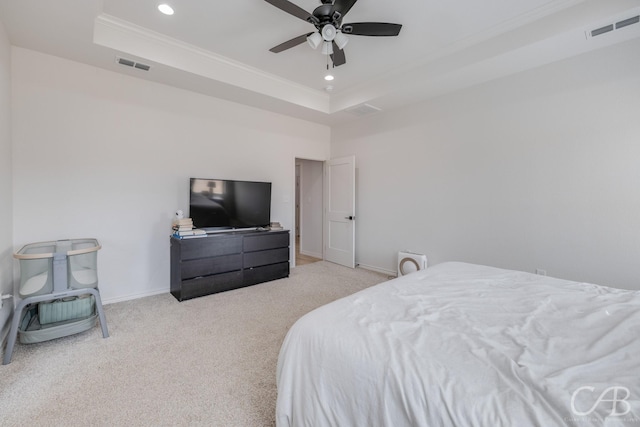 bedroom with ceiling fan, a raised ceiling, and light carpet