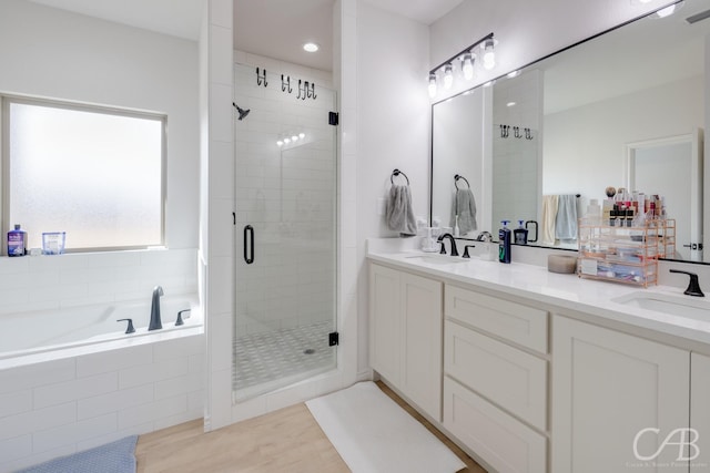 bathroom featuring vanity and shower with separate bathtub